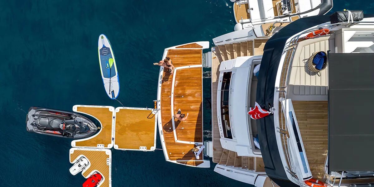 Aerial view of M/Y Lio Black Knight Sunseeker 95 with water toys deployed — yacht charter Balearic Islands