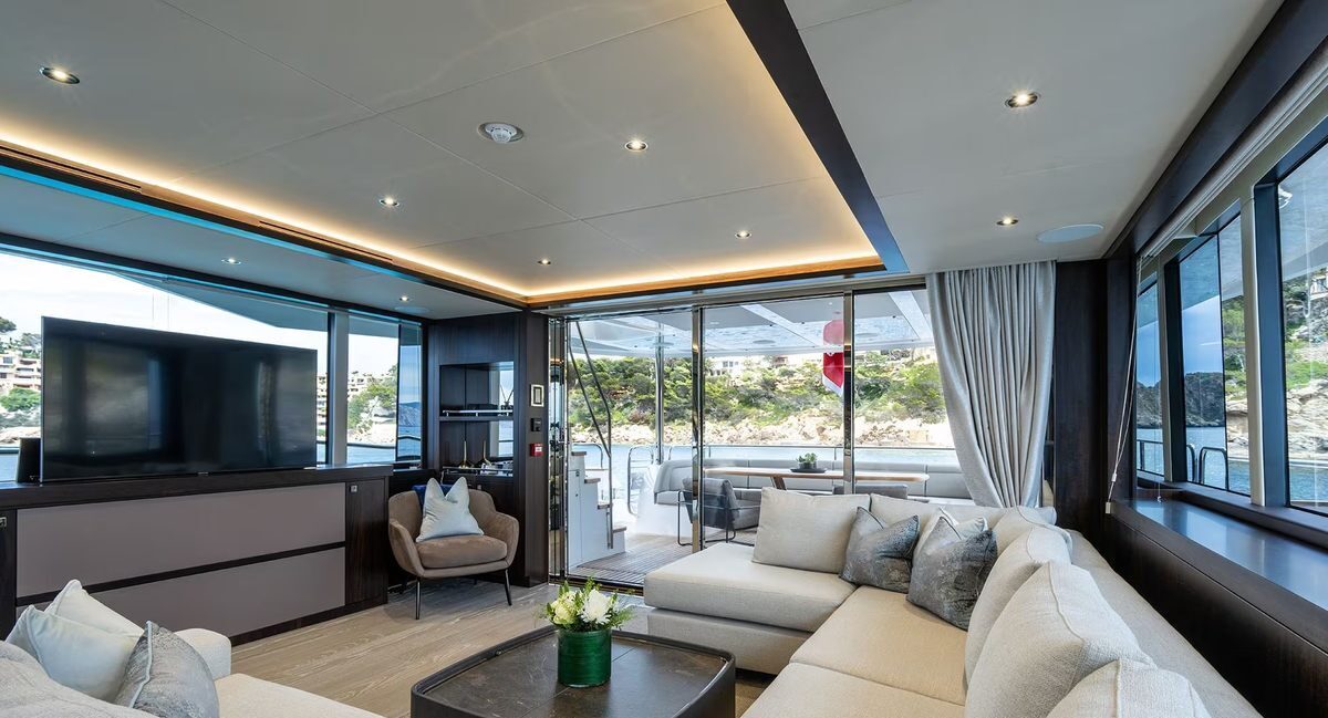 Stewardess providing attentive service aboard M/Y Lio Black Knight Sunseeker 95 — luxury charter crew