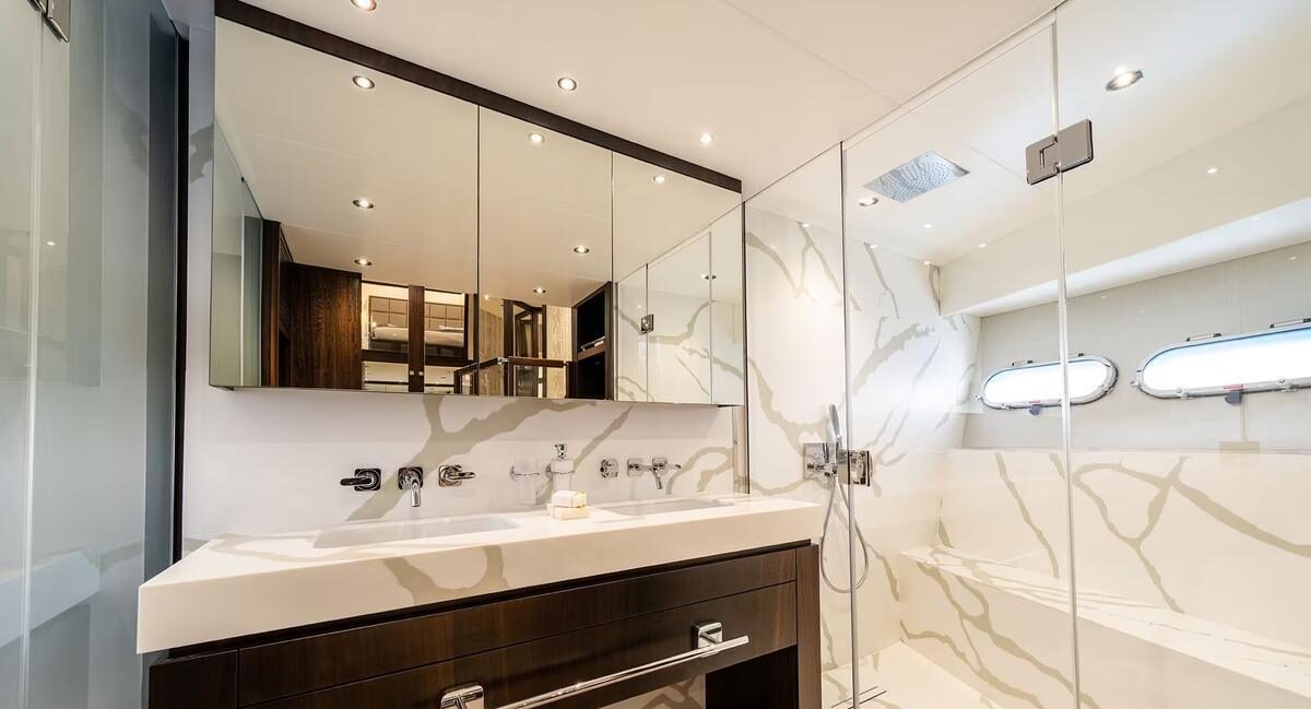 M/Y Lio Black Knight Sunseeker 95 guest cabin with branded towels — luxury charter details