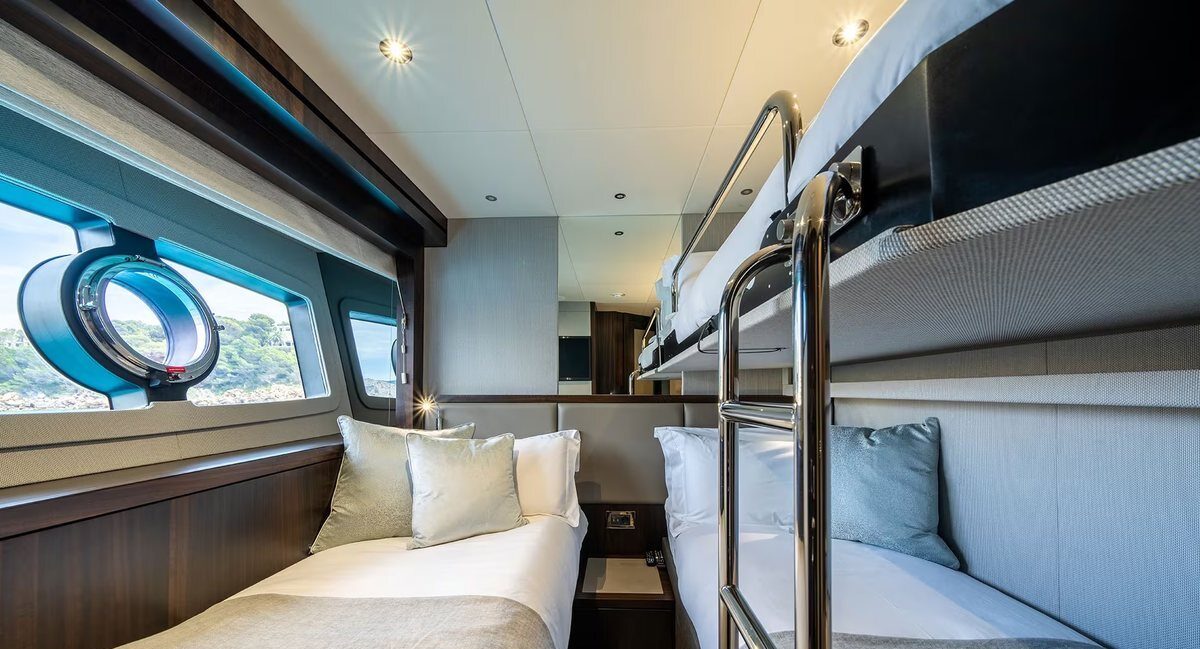 M/Y Lio Black Knight Sunseeker 95 master cabin with branded towels — luxury charter details