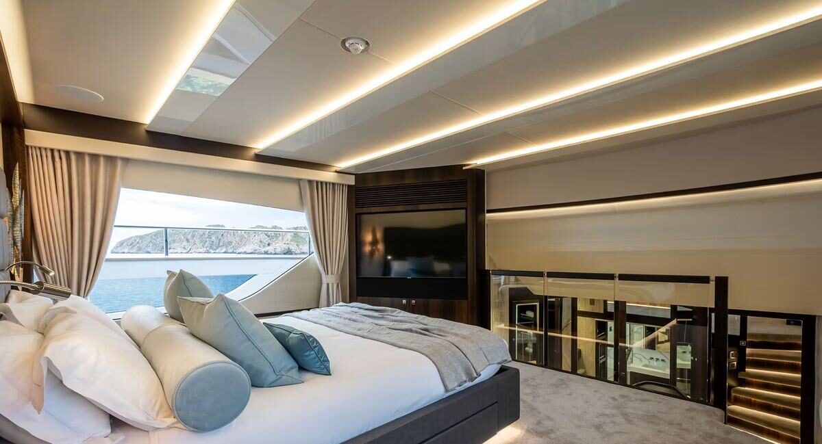 Couple strolling the side deck of M/Y Lio Black Knight Sunseeker 95 — luxury charter Balearic Islands