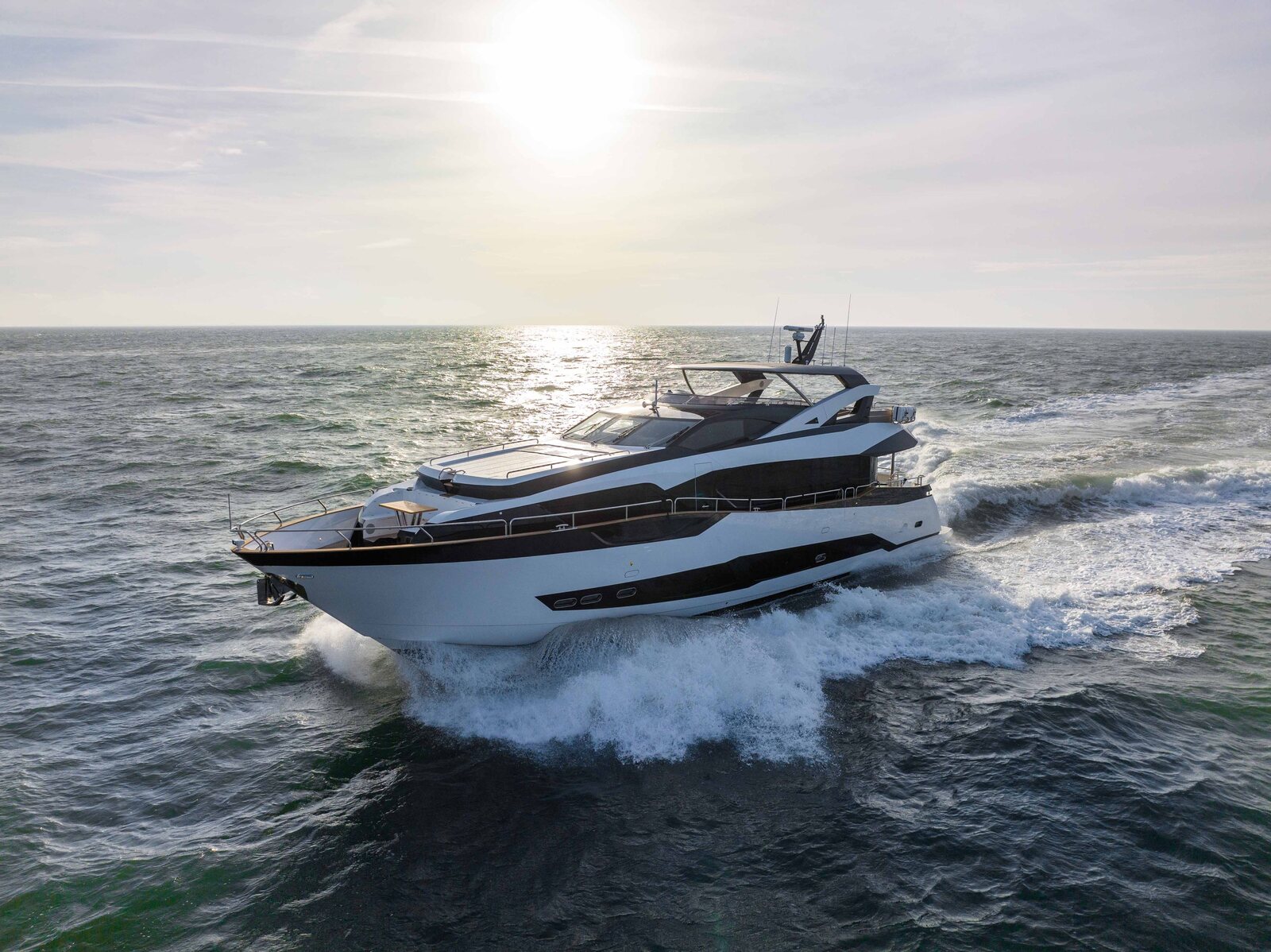 M/Y Lio Black Knight Sunseeker 95 cruising into sunset — yacht charter Mallorca and Ibiza