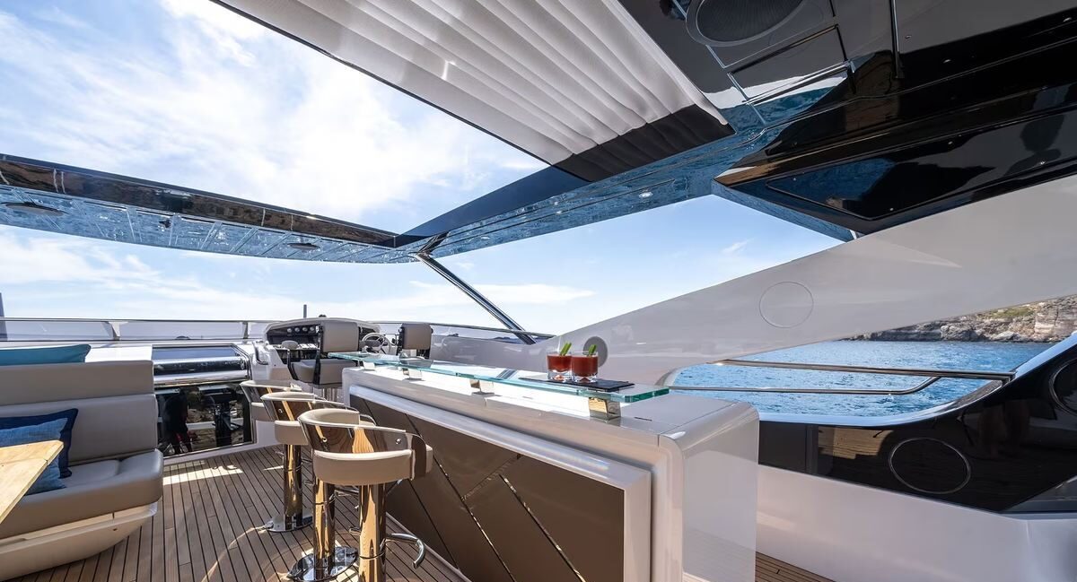 Guest lounging at sunset on aft deck of M/Y Lio Black Knight Sunseeker 95 — luxury charter Mallorca